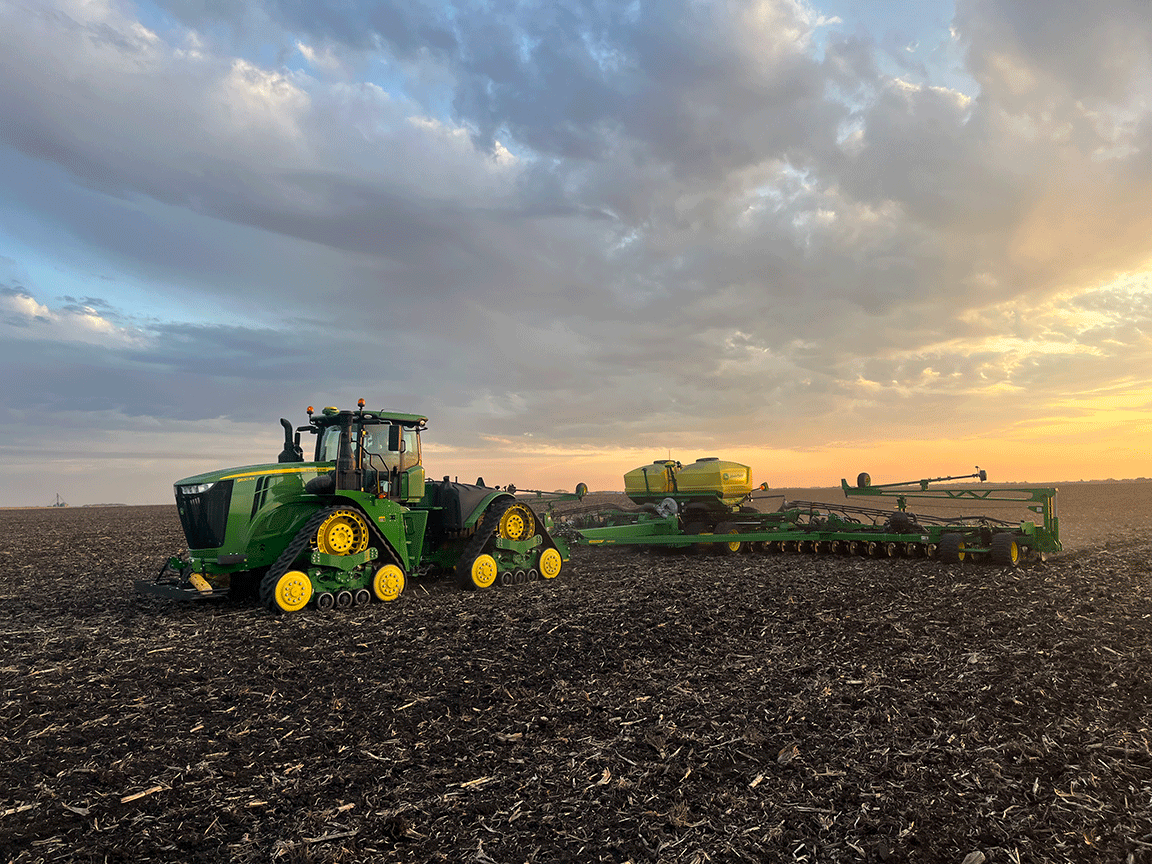 Cale and Connor Juergensen and planting tractor in field