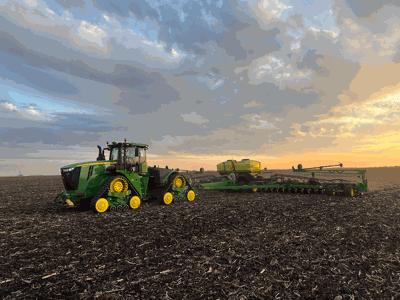 Cale and Connor Juergensen and planting tractor in field