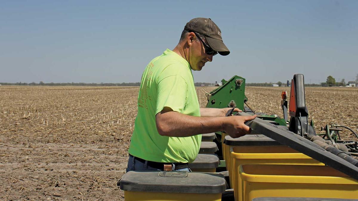 Shane McKibbon checks seed
