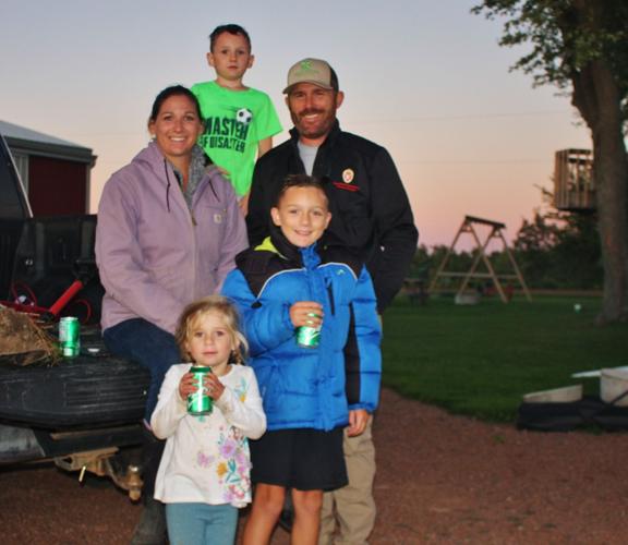 Jocelyn Cavadini with her son Micah, 6, at her shoulder, poses with Noelle, 4, Silas, 8, and Jason Cavadini