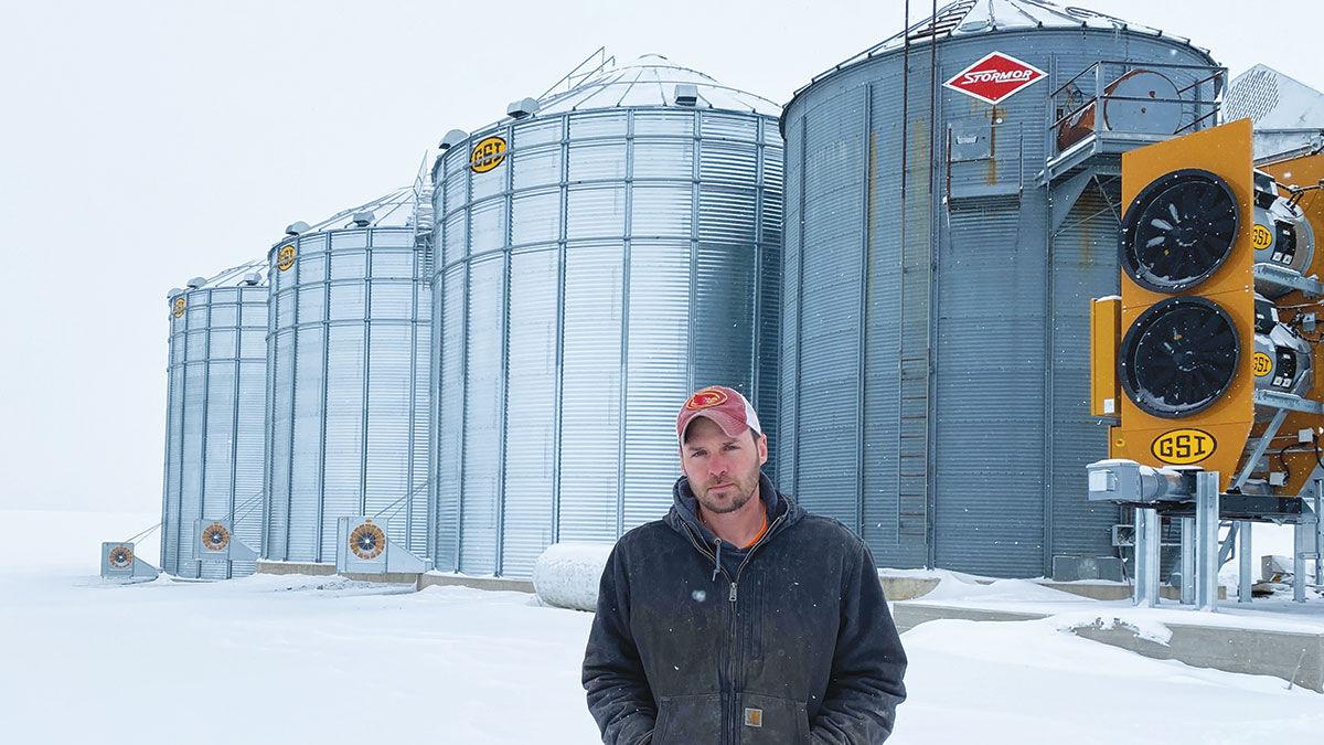 Ryan Vavroch stands in front of his grain bins