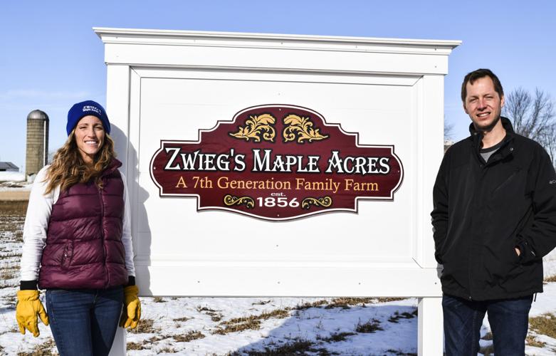 Rachel and Kyle Zwieg with farm sign