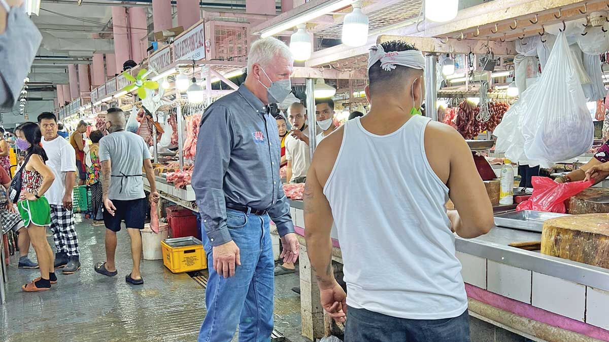 Scott Phillips tours a wet market where pork is sold