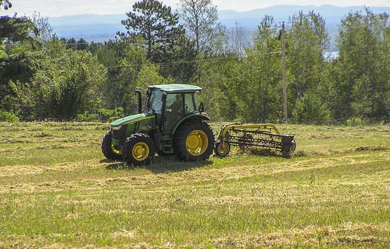 Tractor in field with hay rake