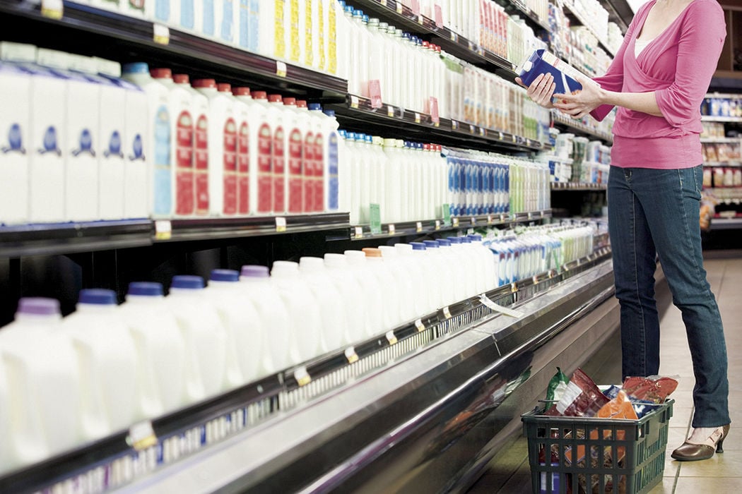Shopper at dairy milk in store