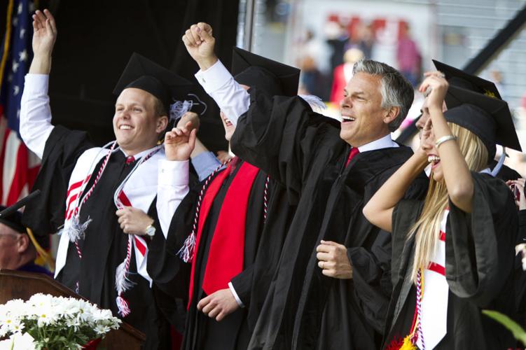 UW commencement Huntsman jump around
