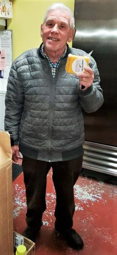 Gary Haas holds cheese donation to Southwestern Food Pantry