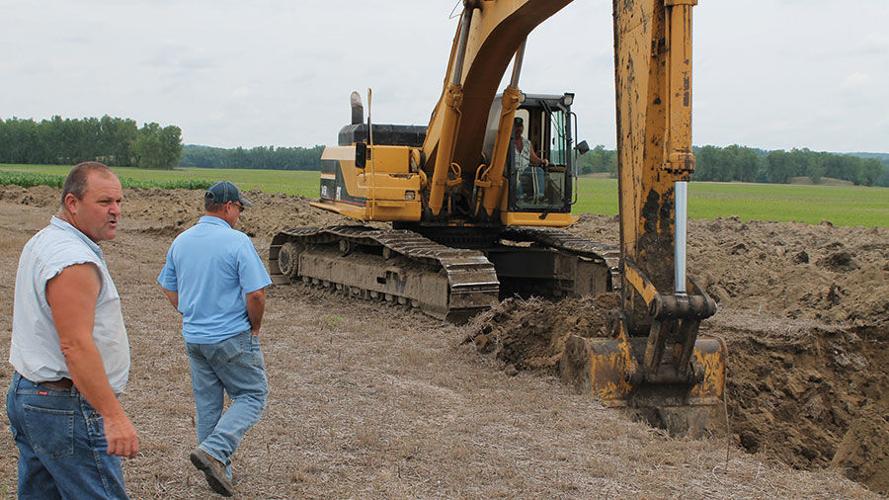 excavator reclaiming MO soil