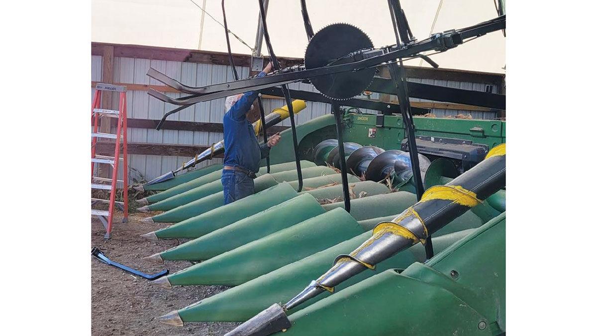 Sam Bieri installs a reel during harvest