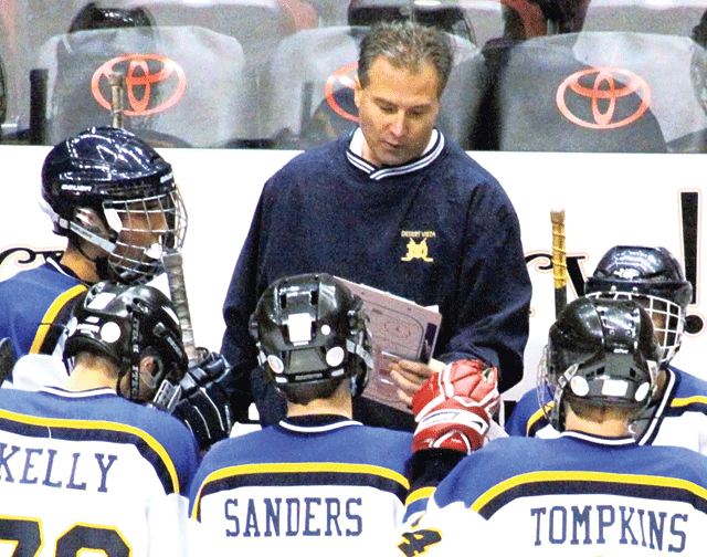 DV hockey coaching team hanging up skates 
