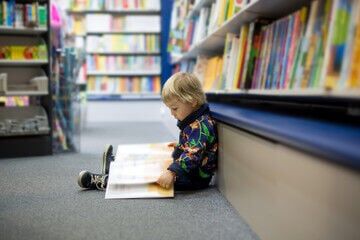 child with book at a bookstore