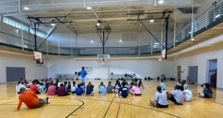 Micah Moon speaks at YMCA Youth Basketball Camp
