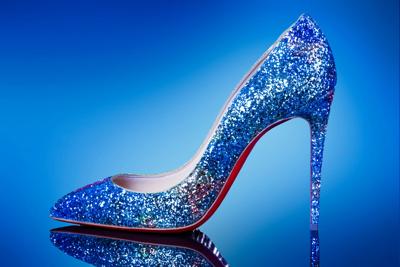 Woman shoe on high heel on the blue background.