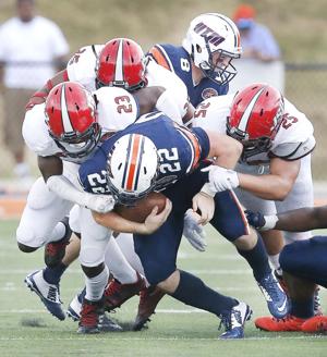 Jacksonville State safety Brandon Bender leads the JSU D as they tackle UT Martin's Trent Garland during the JSU at UT Martin football game. Photo by Stephen Gross / The Anniston Star.