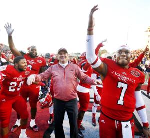 JSU head coach John Grass celebrates with quarterback Eli Jenkins and the rest of the Gamecocks after winning in overtime during the second round of the FCS playoffs Saturday on Burgess-Snow Field. Photo by Stephen Gross / The Anniston Star