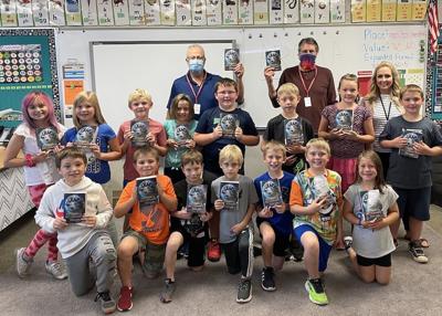 Third-graders get dictionaries from Rotarians