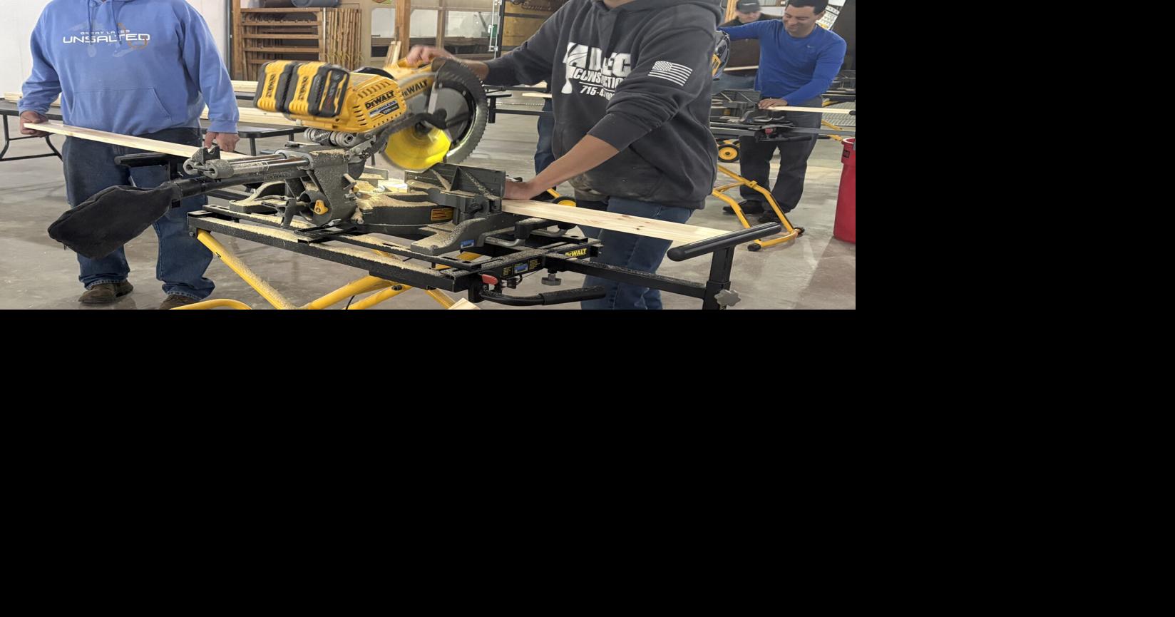 Volunteers join forces to construct twin beds for kids in need