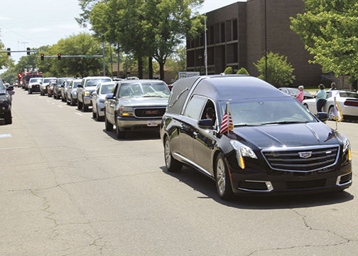 Police and fire departments escort Mayor Scott McCormick's last ride through Crossett