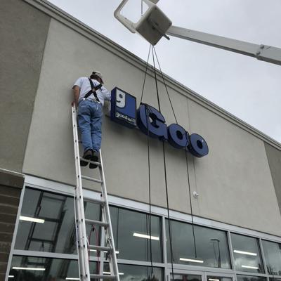 Workers mount new Goodwill sign