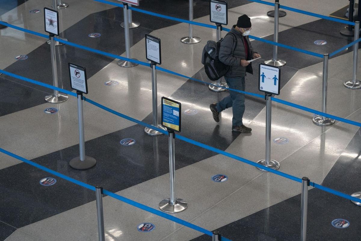 A traveler makes his way through a security line Nov. 29, 2020, in Terminal 3 at O'Hare International Airport in Chicago.
