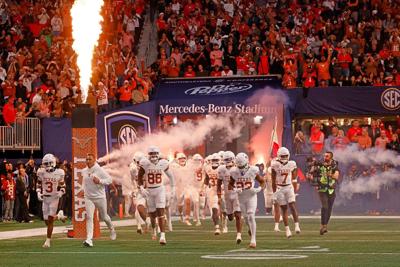 Texas head coach Steve Sarkisian and his players run out to the field before the Southeastern Conference championship NCAA college football game against Georgia at Mercedes-Benz Stadium, Saturday, Dec. 7, 2024 in Atlanta.