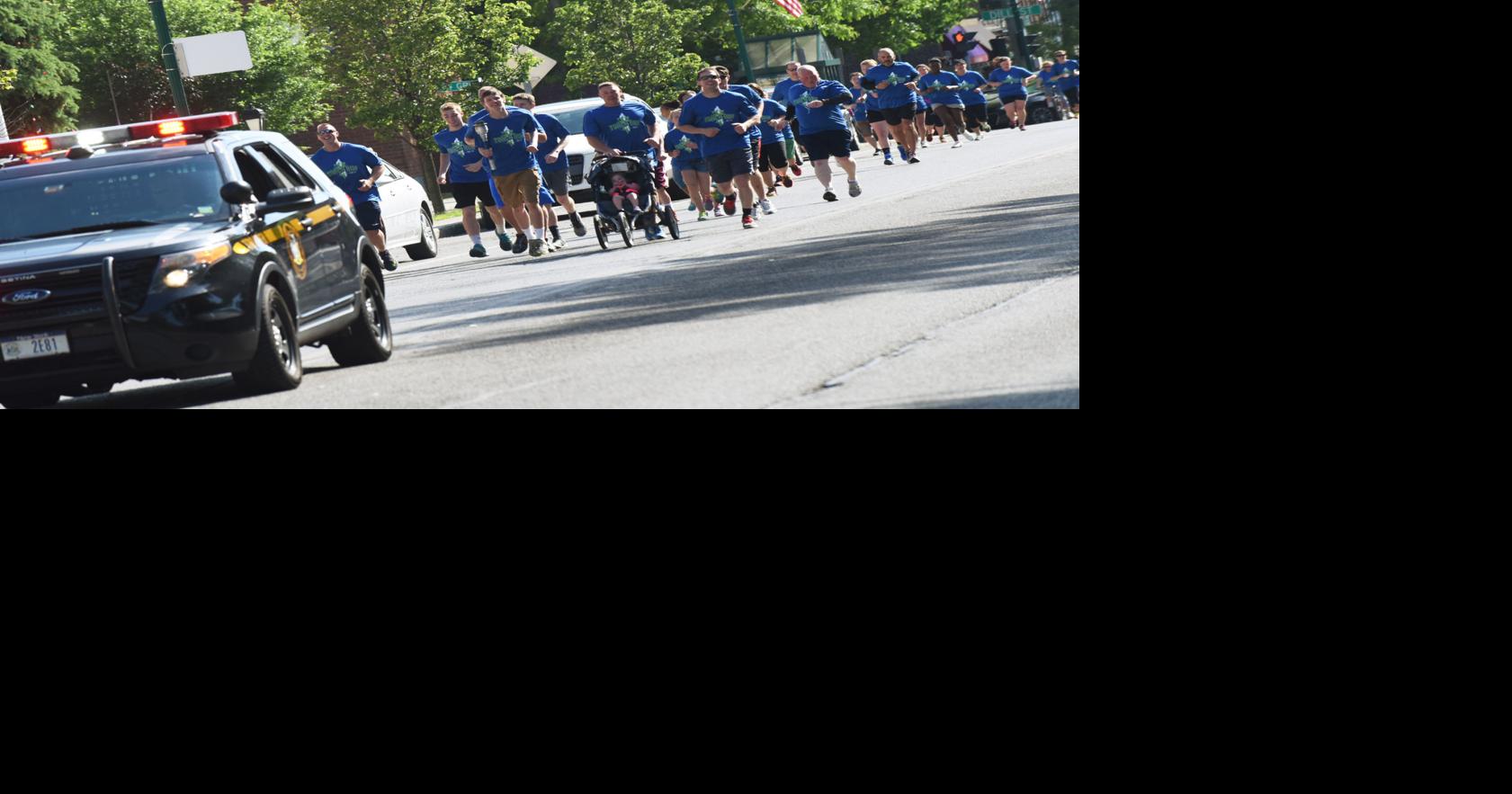 Law enforcement members escort Special Olympics New York torch across