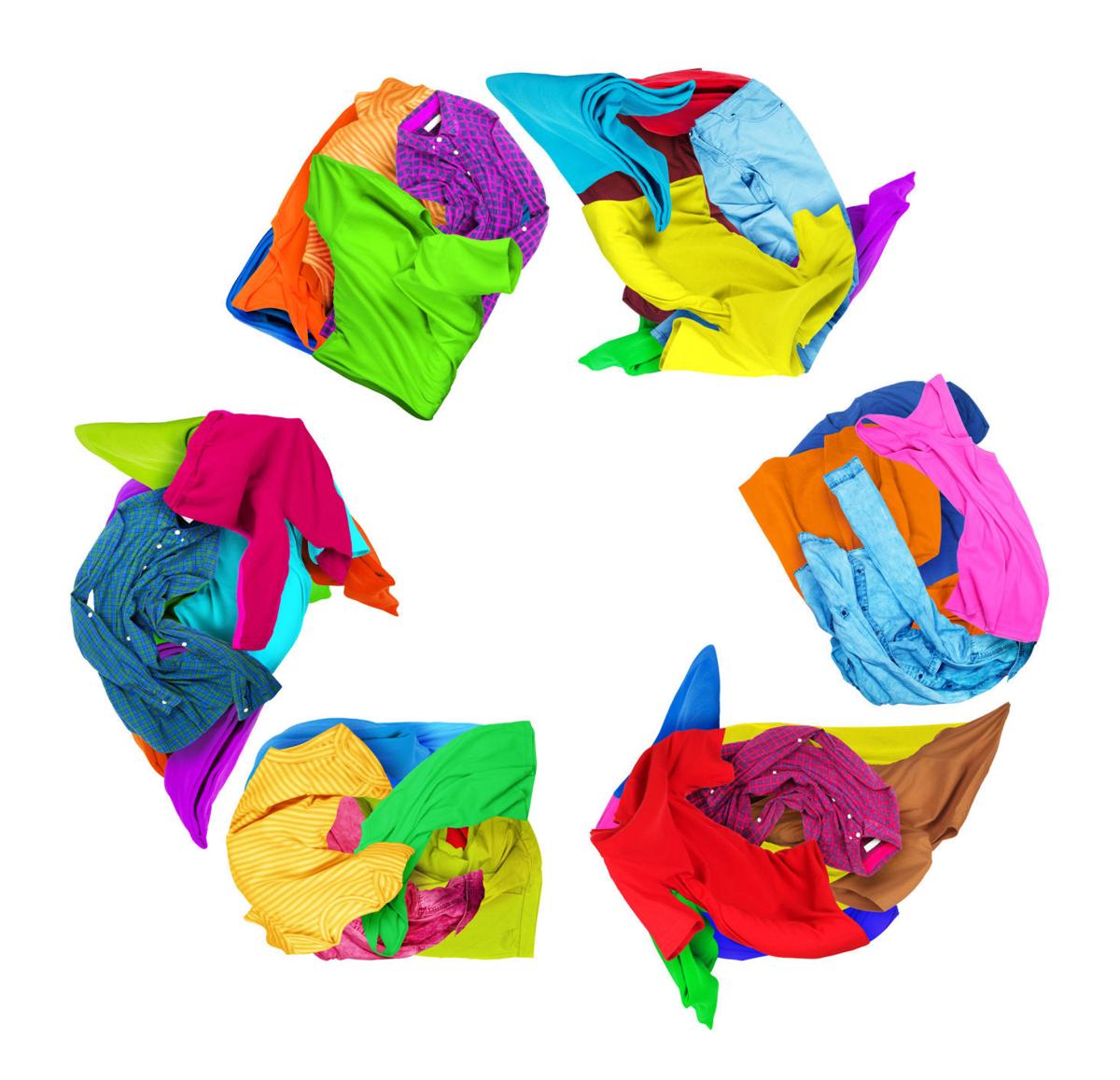 Clothes folded in a recycling sign on a white background