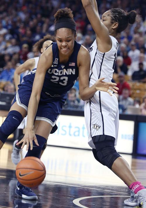Connecticut's Azura Stevens (23) drives against UCF's Nyala Shuler at CFE Arena in Orlando, Fla., on February 7, 2018.