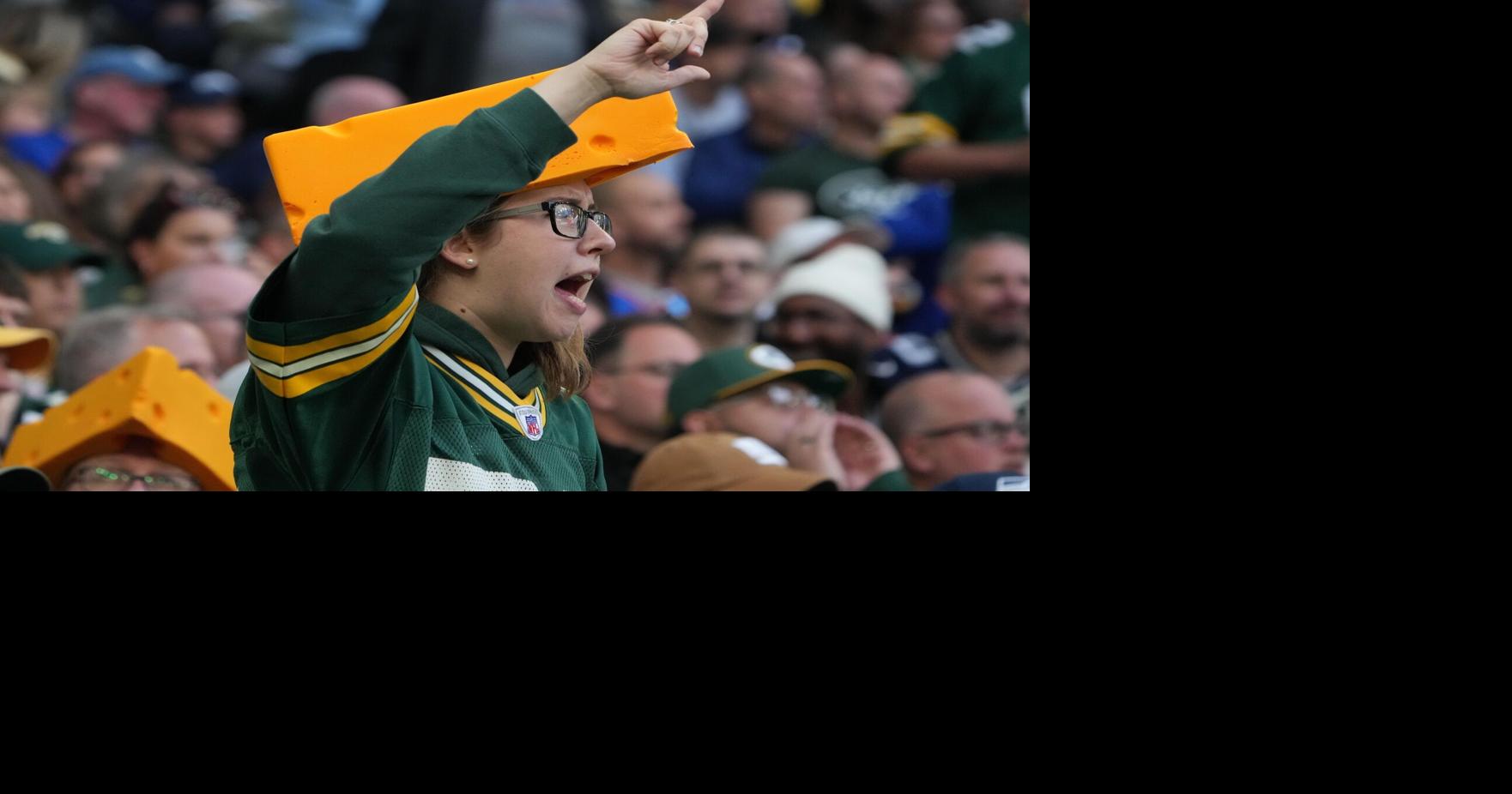 Oct 9, 2022; London, United Kingdom; A Green Bay Packers female fan wearing a Cheesehead reacts during an NFL International Series game against the New York Giants at Tottenham Hotspur Stadium. Mandatory Credit: Kirby Lee-USA TODAY Sports