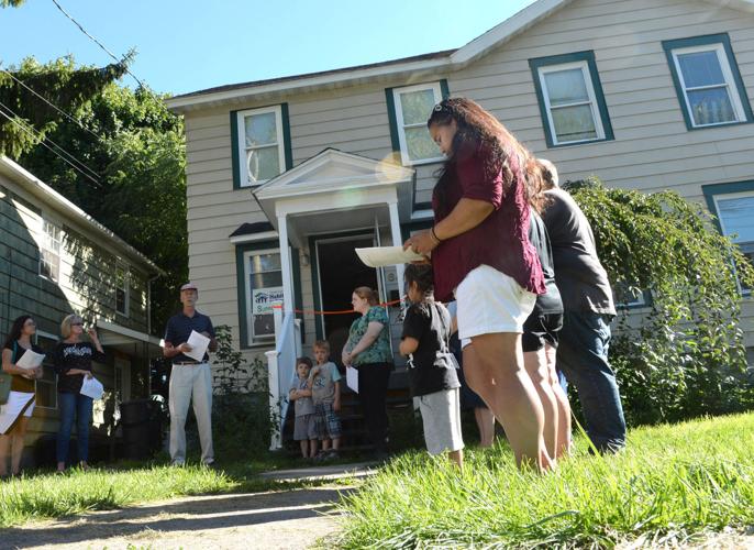 Two Auburn families move into renovated Habitat for Humanity homes