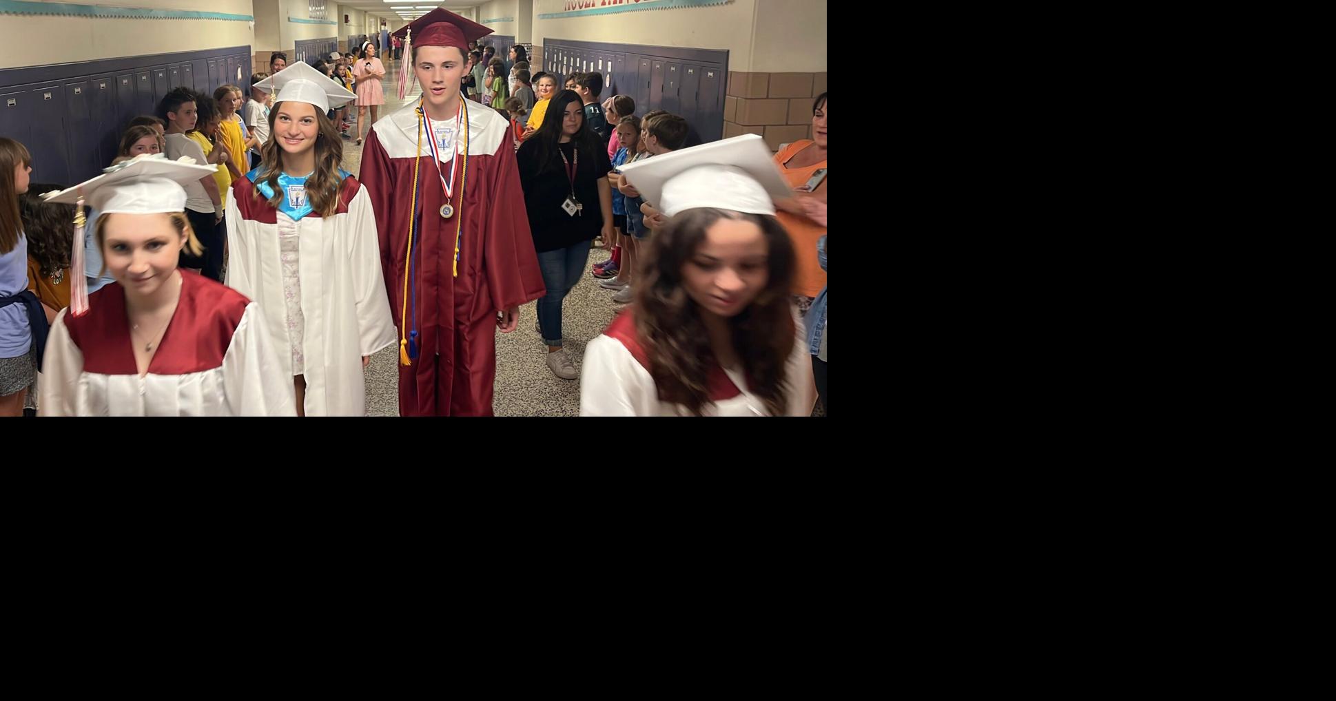 Video Auburn grads return to their roots parading the halls of their