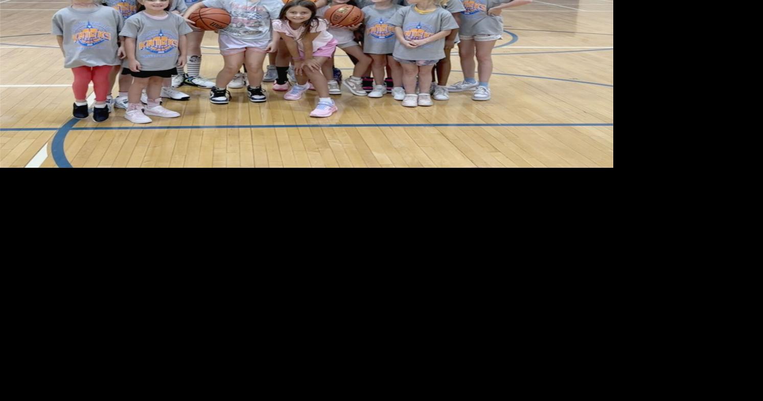 Andrea Stinson and female campers pose for a group photo after Stinson led the players through drills on the Newland Elementary School basketball court during the Burleson Basketball Camp.jpg