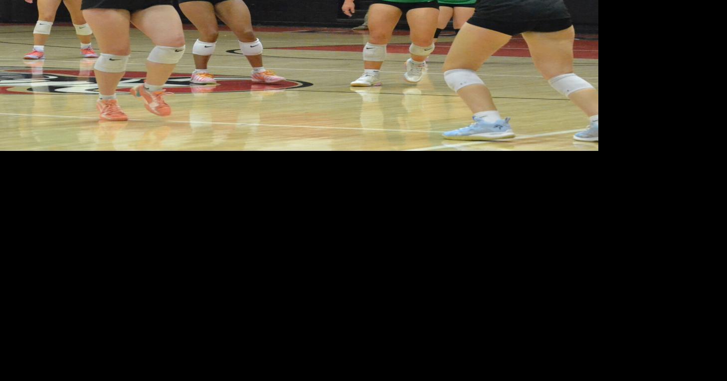 Hailey Triplett sets a ball for teammate Macie Turner in Avery's volleyball win over Mountain Heritage