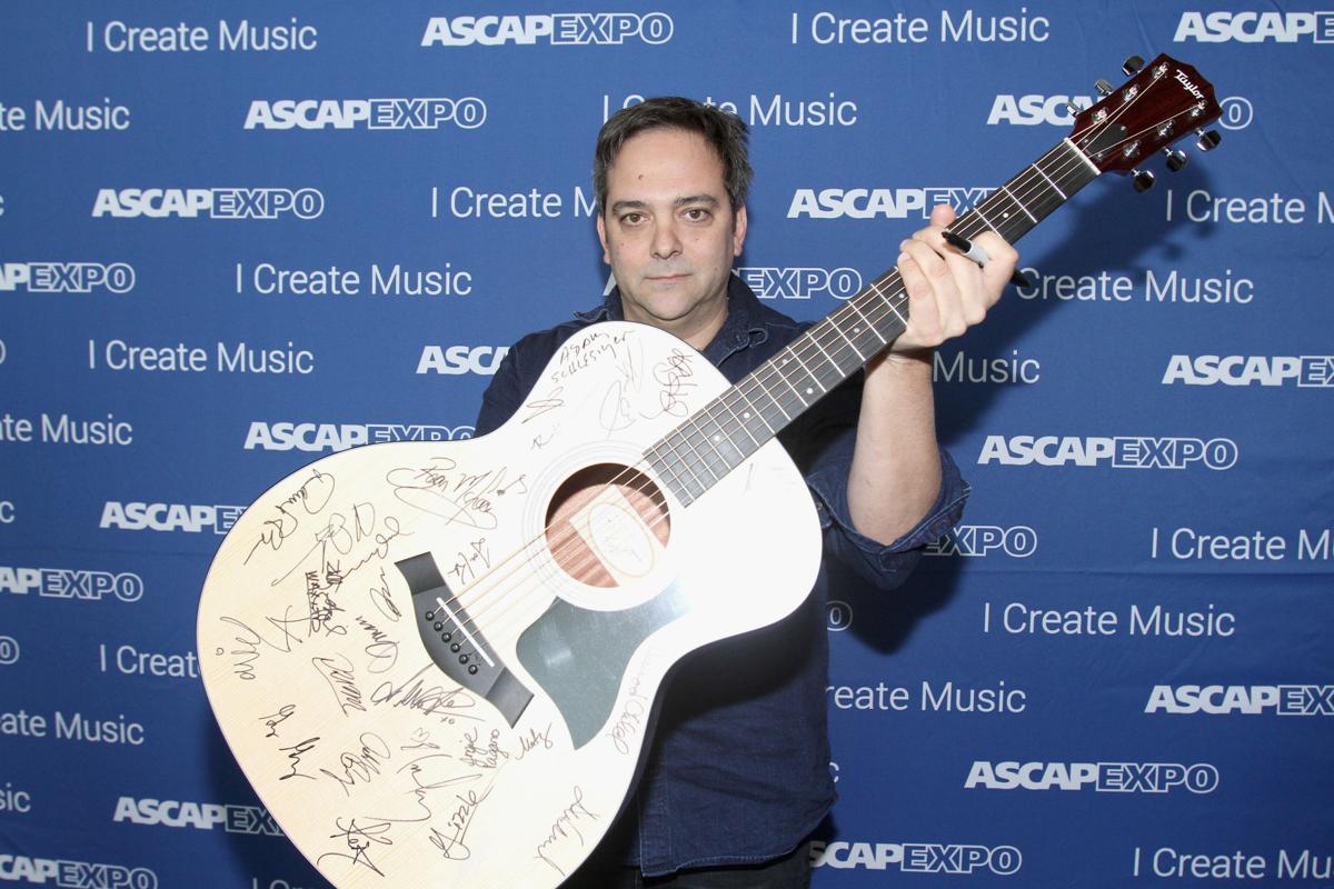 Composer Adam Schlesinger poses with a #StandWithSongwriters guitar, which will be presented in May to members of Congress to urge them to support reform of outdated music licensing laws, during the 2016 ASCAP "I Create Music" EXPO on April 30, 2016 in Los Angeles. Schlesinger is in an upstate New York hospital battling the coronavirus.