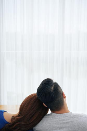 Tender embracing couple on sofa
