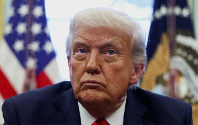 U.S. President Donald Trump signs executive orders in the Oval Office at the White House