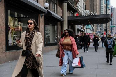 A woman carries shopping bags in Manhattan in New York City