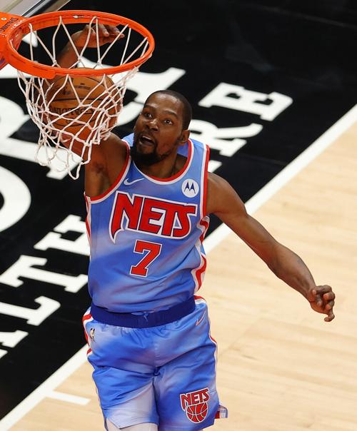 The Brooklyn Nets' Kevin Durant dunks against the Atlanta Hawks during overtime at State Farm Arena in Atlanta on Wednesday, Jan. 27, 2021.