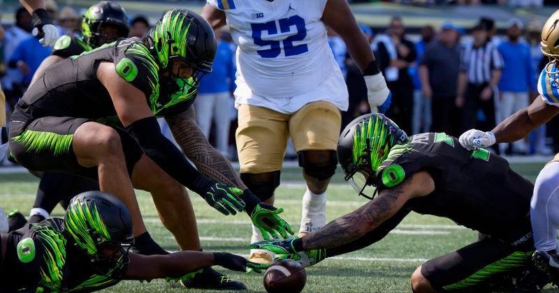 Oregon defensive back Koi Perich, right, dives on a fumbled ball as the Oregon Ducks host the UCLA Bruins on Oct. 10, 2026, at Autzen Stadium in Eugene, Oregon.