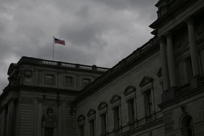 An American flag waves in the wind atop the Library of Congress on Capitol Hill in Washington