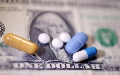 Illustration shows U.S. dollar banknote and medicines
