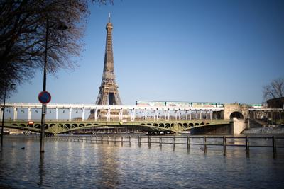 It could be a while before Americans get to take in this view of the Seine with the Eiffel Tower in person.