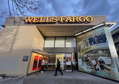 FILE PHOTO: A man walks from a branch of Wells Fargo bank in the University District of Seattle