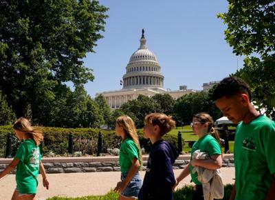 FILE PHOTO: People walk past the US Capitol in Washington