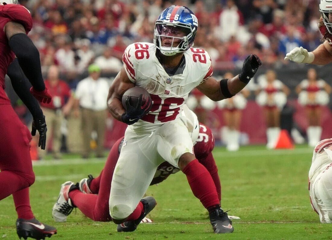 New York Giants running back Saquon Barkley (26) runs the ball against the  Arizona Cardinals during the first half of an NFL football game, Sunday,  Sept. 17, 2023, in Glendale, Ariz. (AP