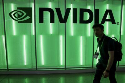 A person walks pass a Nvidia logo at Computex in Taipei