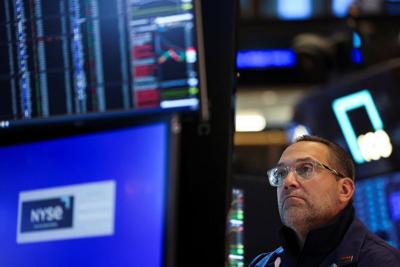 A trader works on the floor at the New York Stock Exchange (NYSE) in New York City