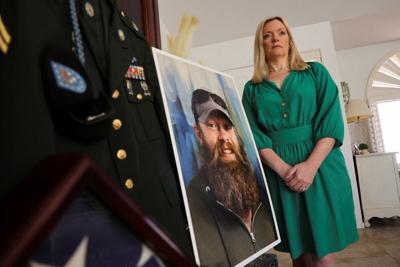Stacey Wales stands next to a photo of her brother, Chris Pelkey, who died in a road rage shooting in 2021, in Chandler, Arizona