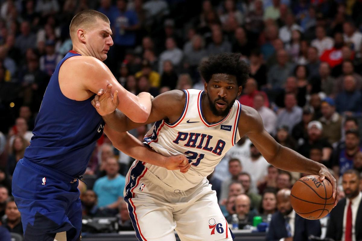 Nikola Jokic #15 of the Denver Nuggets guards Joel Embiid #21 of the Philadelphia 76 ers in the fourth quarter at the Pepsi Center on November 08, 2019 in Denver.