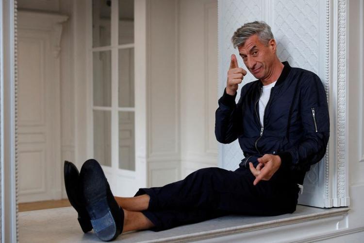 FILE PHOTO: Italian artist Maurizio Cattelan poses prior to the opening of the exhibition "Not Afraid of Love" at the Hotel de la Monnaie in Paris